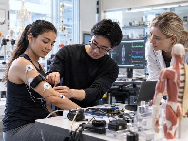 Biomedical engineers testing a sensor device in a university laboratory