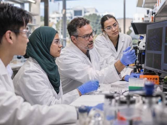 Researchers reviewing clinical data at the bench